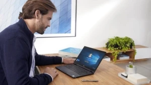 Ein Mann arbeitet am Schreibtisch an einem Laptop