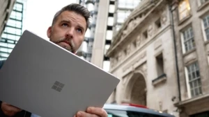 Ein Mann steht auf einer Starße in London und hält ein Surface Device in den Händen