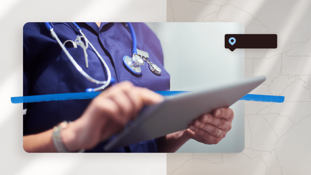 A healthcare professional in a navy uniform with a stethoscope around the neck is holding a tablet.