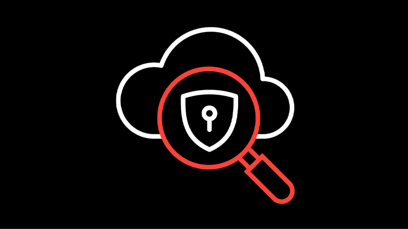 Cloud security scan: magnifying glass over a shield with a lock.