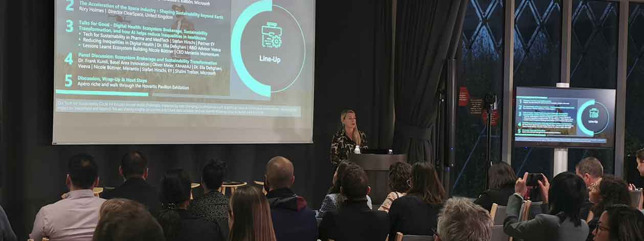 Conference with presentation on screen.