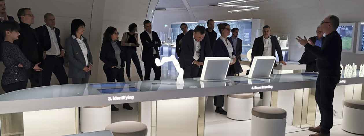 exhibition room with diverse with items on display and people