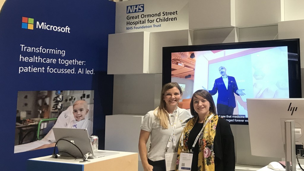 Two women standing in front of a health stand at 2018 Future Decoded