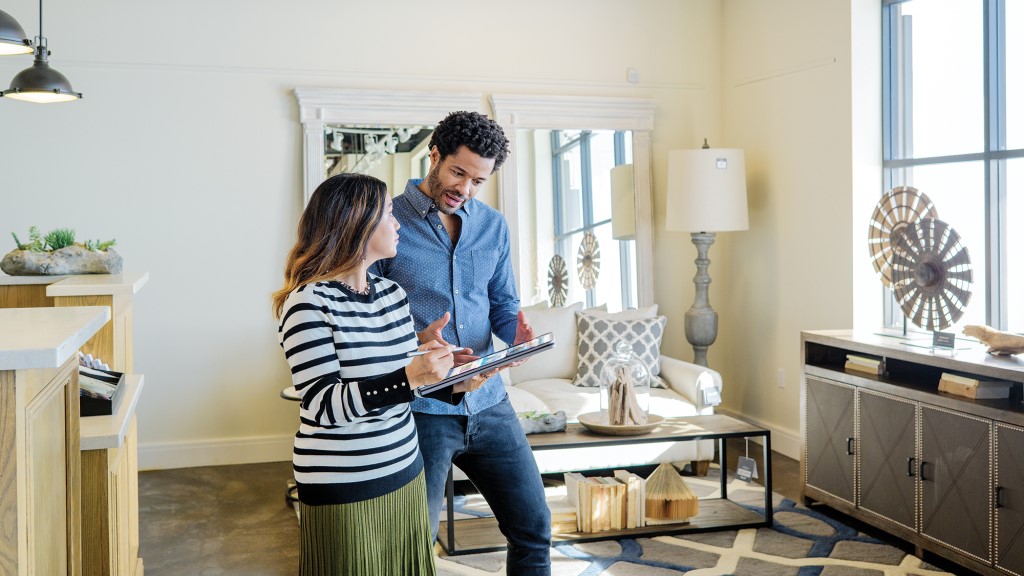 A frontline retail employee talking to a customer