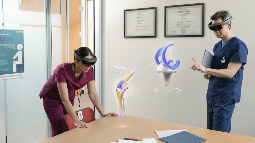 Two medical professionals exploring knee replacement hologram with Microsoft HoloLens for the purpose of surgery 