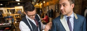 Tailor adjusting a suit jacket