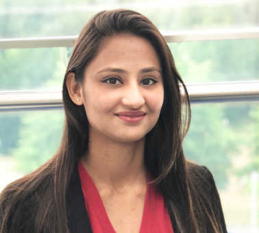 Headshot of a young girl with long, dark hair smiling at the camera.