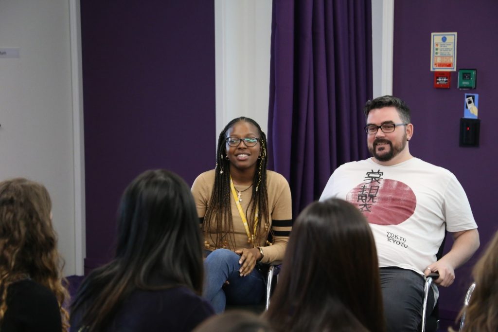 Two people talking in a panel at a Campus 101 event.