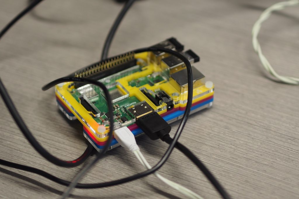 A Raspberry Pi device, with cables attached.
