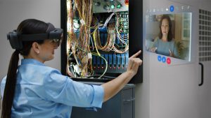 Woman interacing with Remote Assist hologram in a wiring project. Lifestyle photography. Contextual imagery.