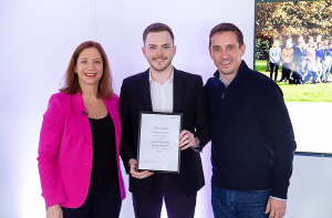 Tom Light holding Microsoft apprenticeships graduation certificate with Clare Barclay, Microsoft UK COO, and Gary Neville