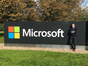 Tom standing by the Microsoft sign on the first day of his apprenticeship