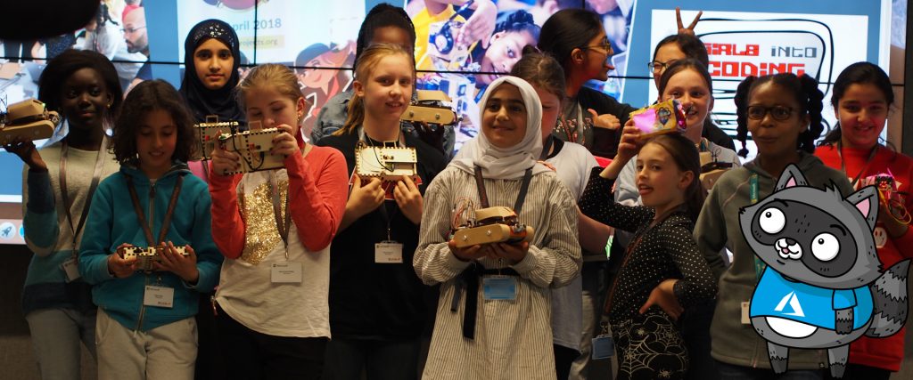 Ayve and a group of girls holding their creations at the third Girls into Coding event.