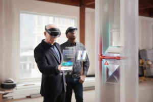 Two men using Microsoft HoloLens 2 in an architecture and construction scenario. Contains hologram scenario.