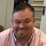 Headshot of Paul Watkins smiling at the camera