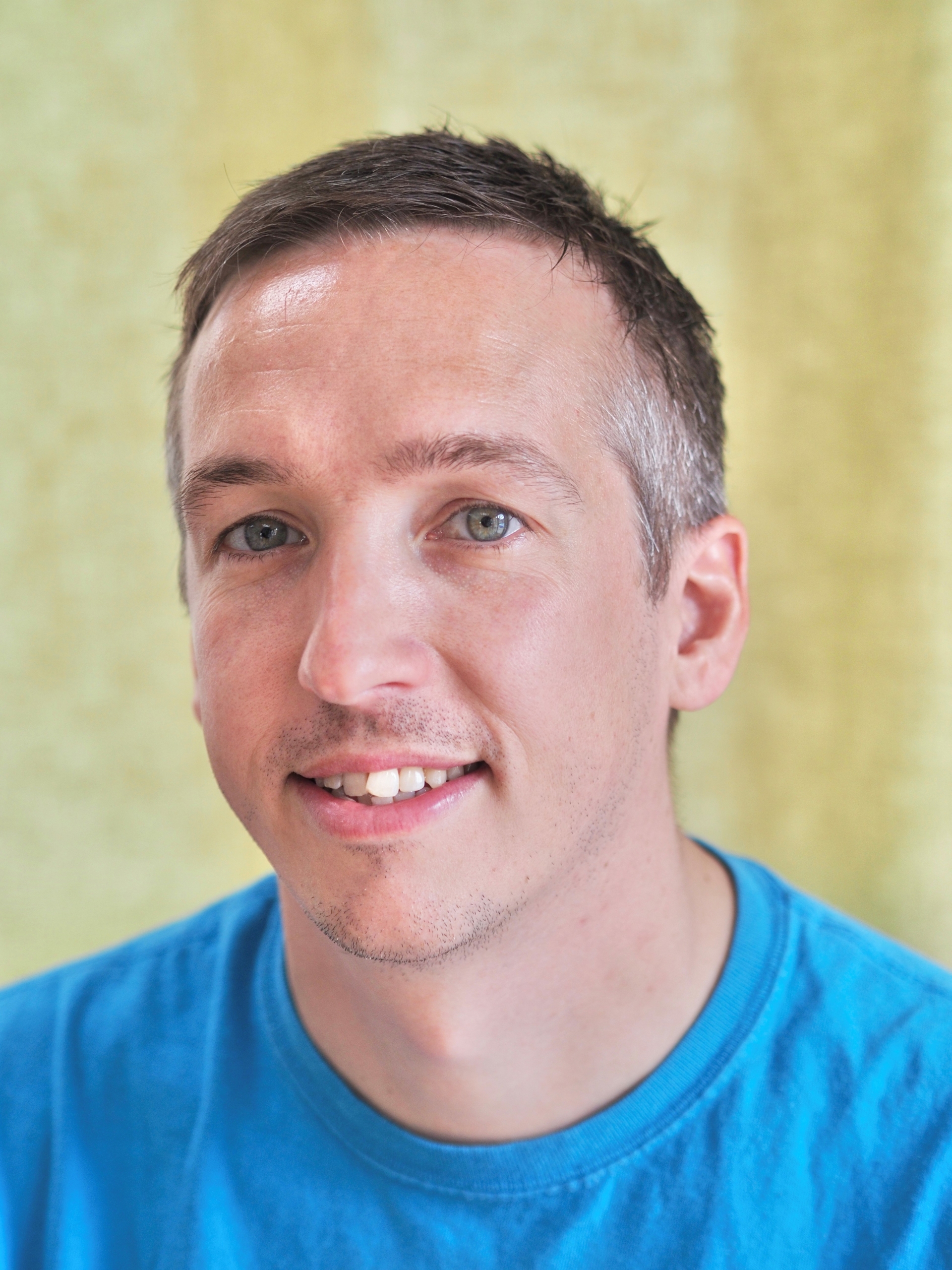 Jon Butler, a smiling man in a blue shirt