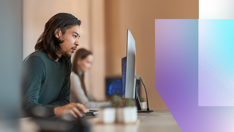 A man sitting at a desk using a computer