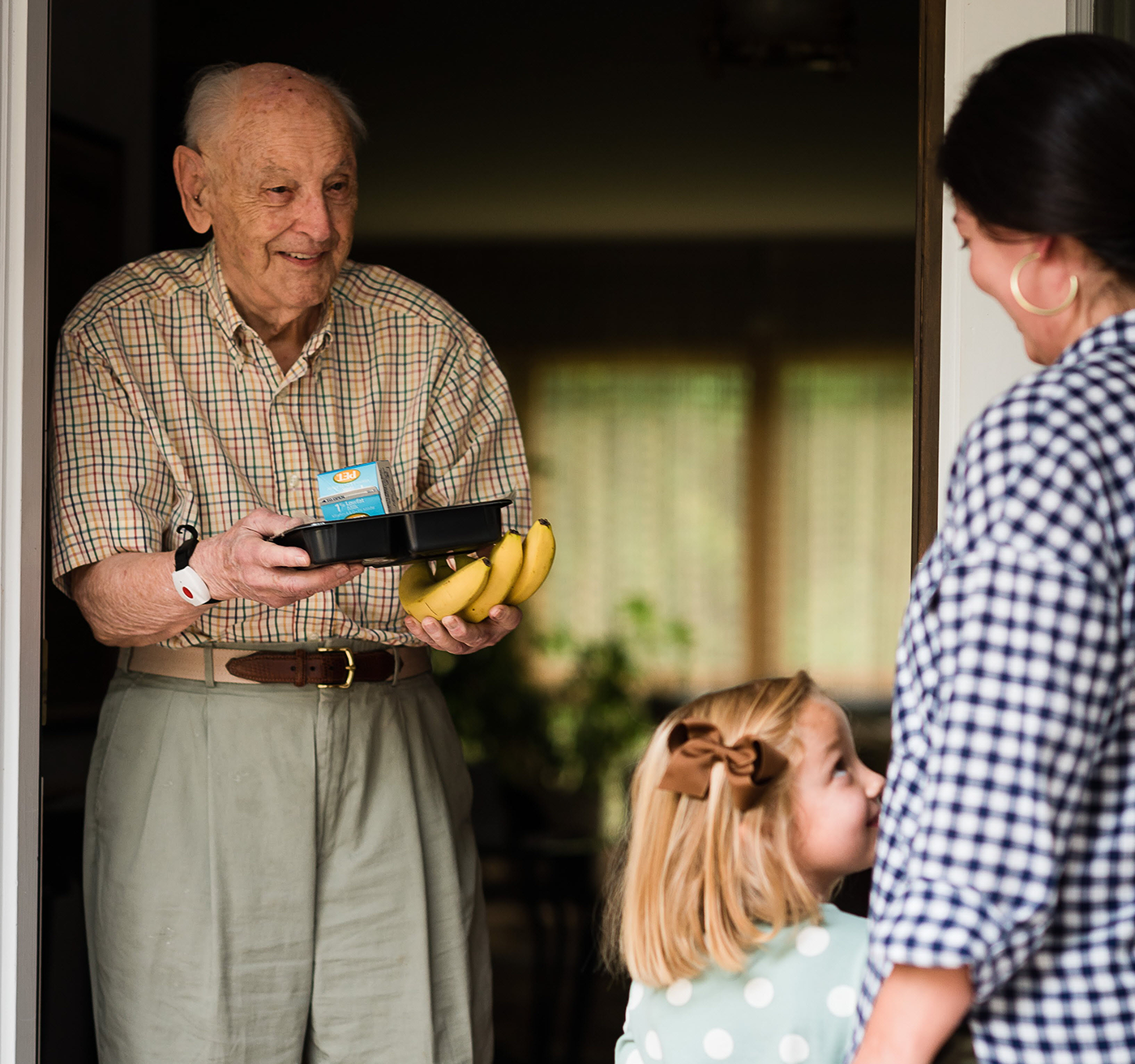 Image of a man receiving goods from Meals on Wheels.