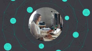 A retail employee working at a Microsoft computer at a clothing store.