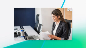 a person sitting at a table using a laptop computer