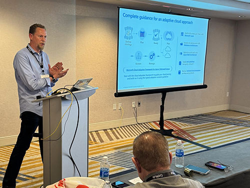 A man gives a presentation in front of an audience.