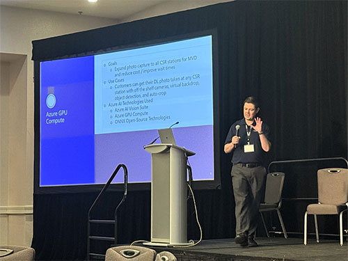 A man at a podium speaks to an audience.