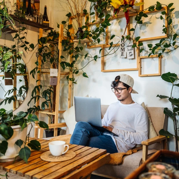 A man sitting on a chair using a laptop