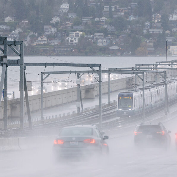 A 4-car train crosses the I-90 floating bridge during the day on December 18, 2025.