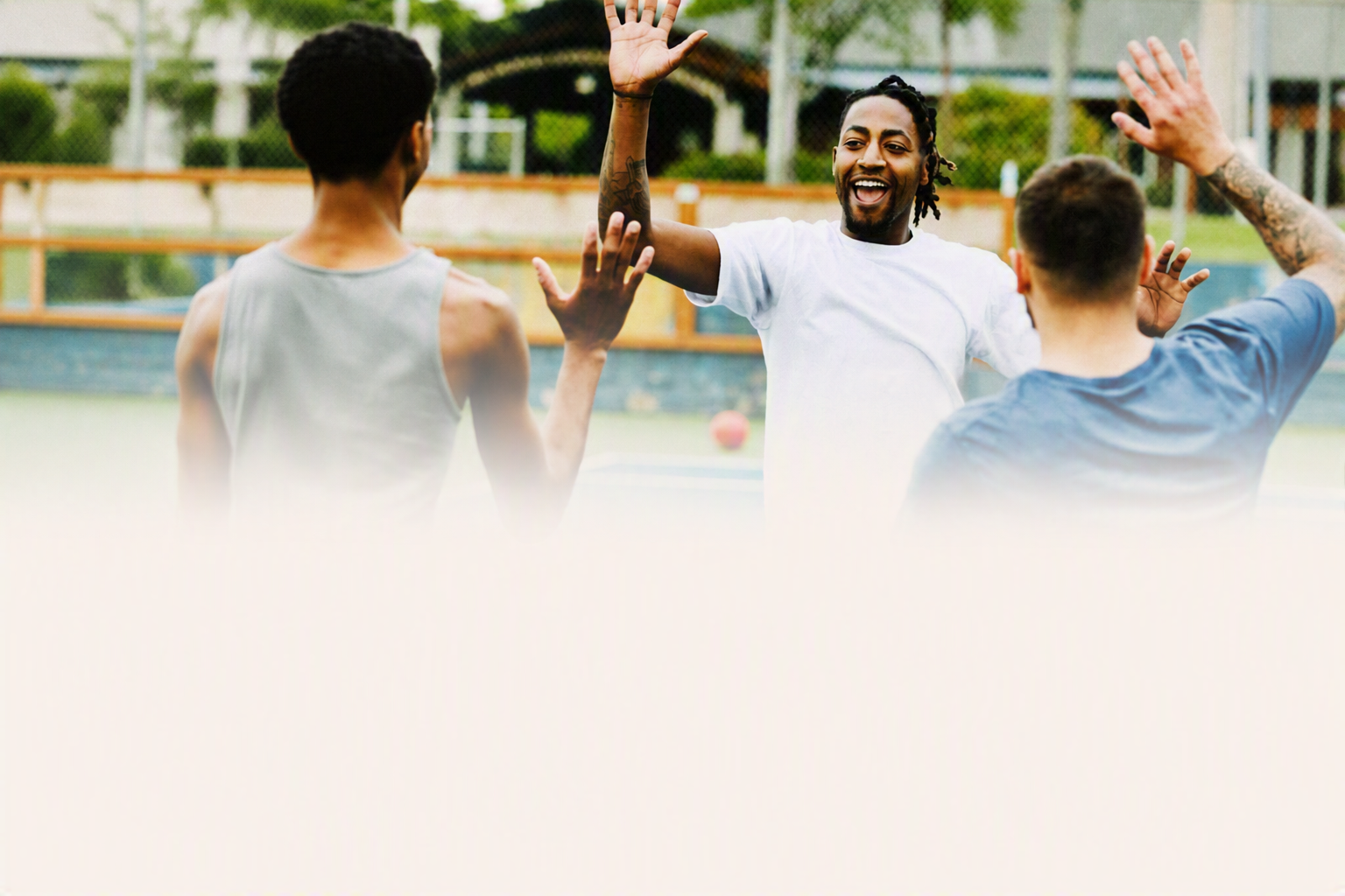 A man in a white shirt high-fives another person outdoors at a community event