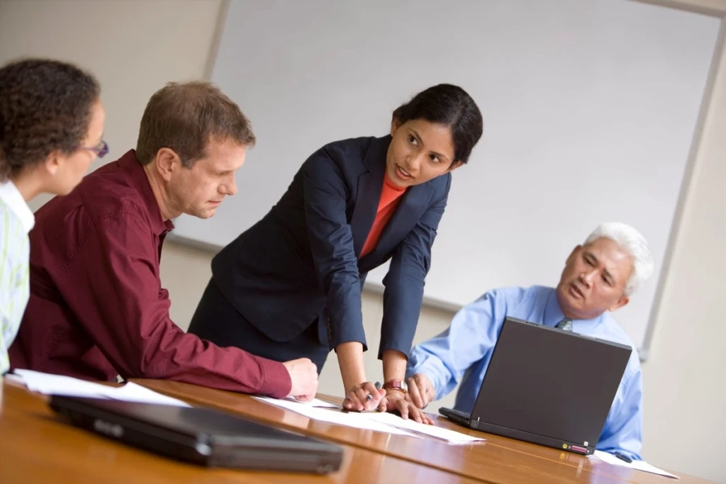 a group of people looking at a computer