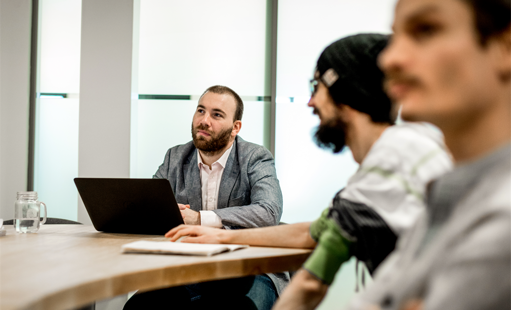 a group of people sitting at a desk