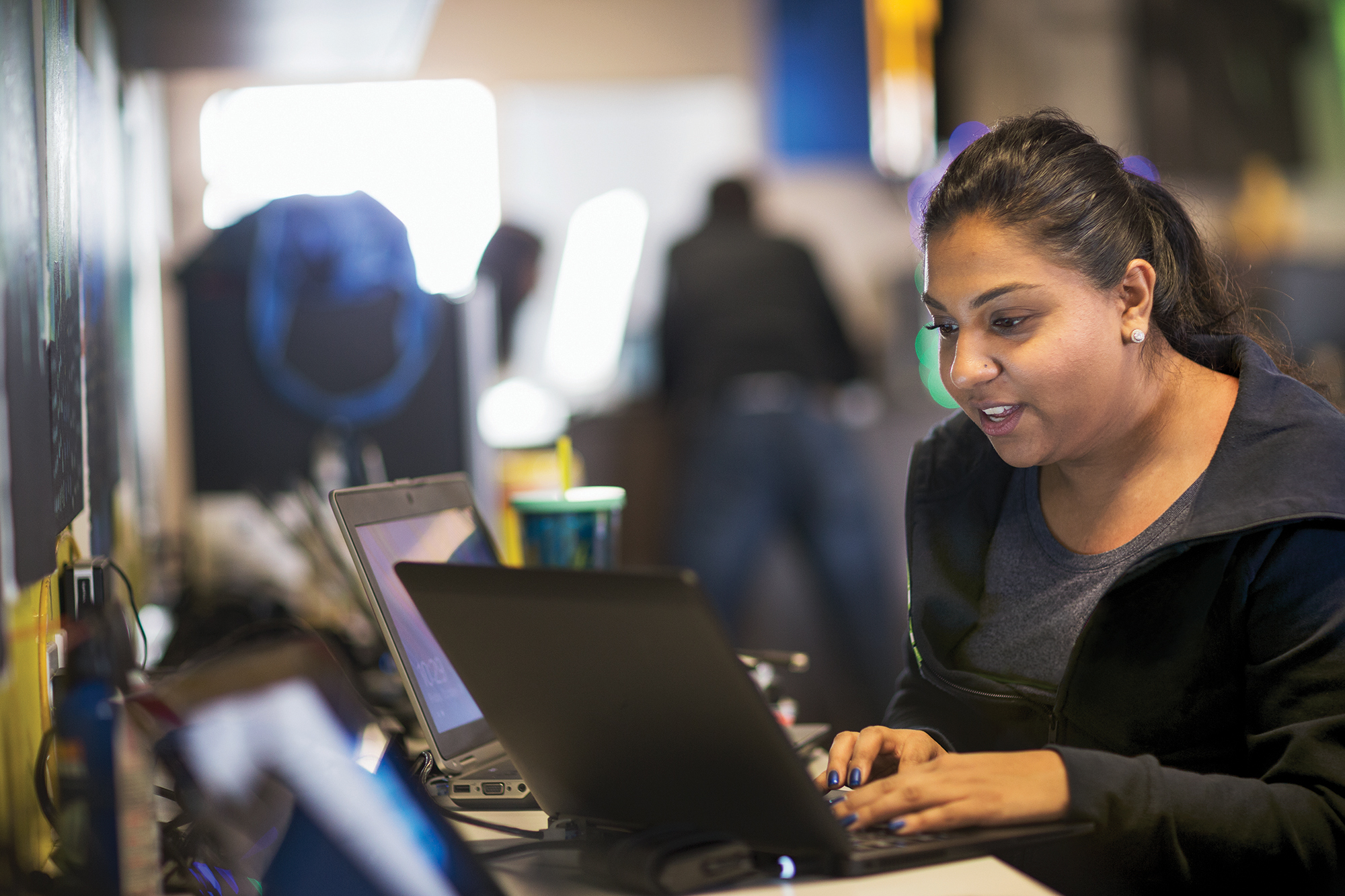 a person sitting at a table using a laptop computer