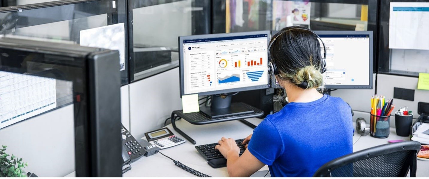 a person sitting at a desk with a computer