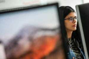 Female working behind computer screen