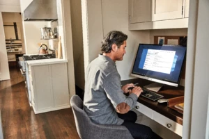 Man interacting with an Asus VivoBook desktop PC.