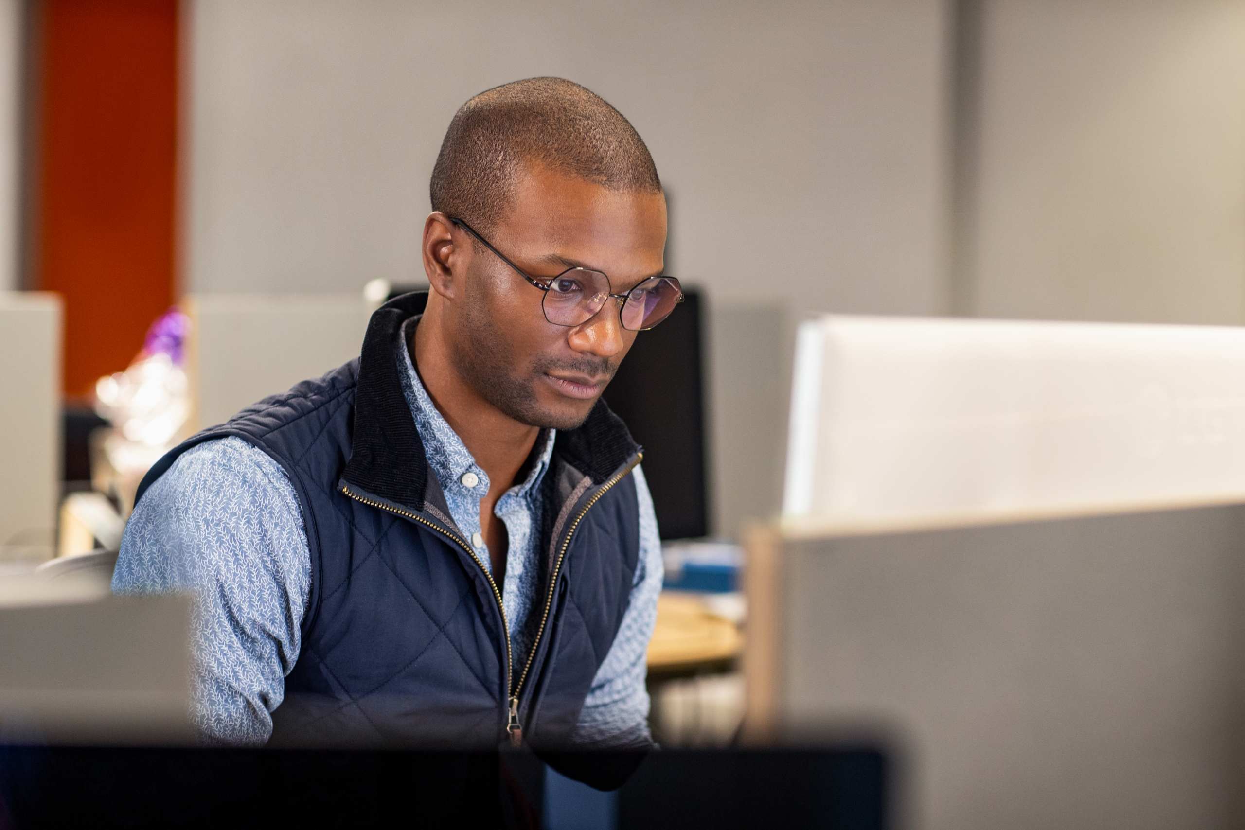 a man sitting at a table using a laptop