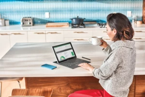 Woman interacting with Samsung GalaxyBook laptop.