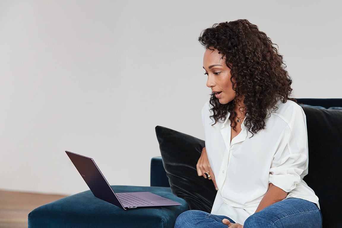 A woman sitting in a chair using a laptop