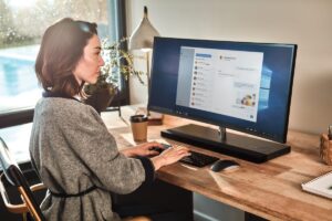 a person sitting at a desk in front of a computer