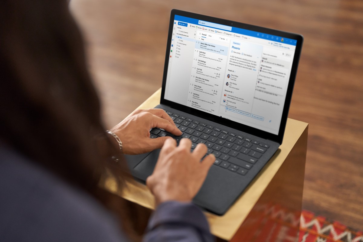 a person using a laptop computer sitting on top of a table