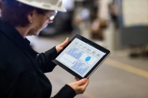 Close up of a person holding a tablet with operations dashboard.