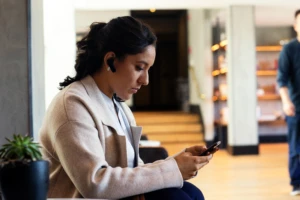 Woman with earpiece and mobile phone