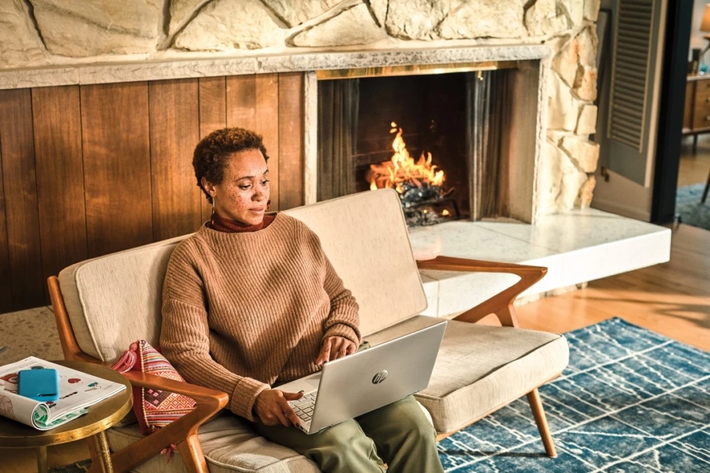 Woman interacting with a HP Pavillion laptop.