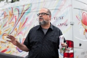 Man in front of a non-profit van.