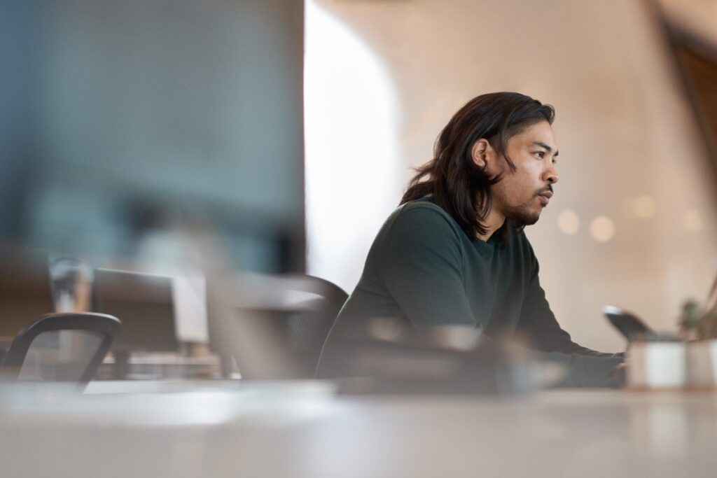 Office worker in focused work with a neutral facial expression.