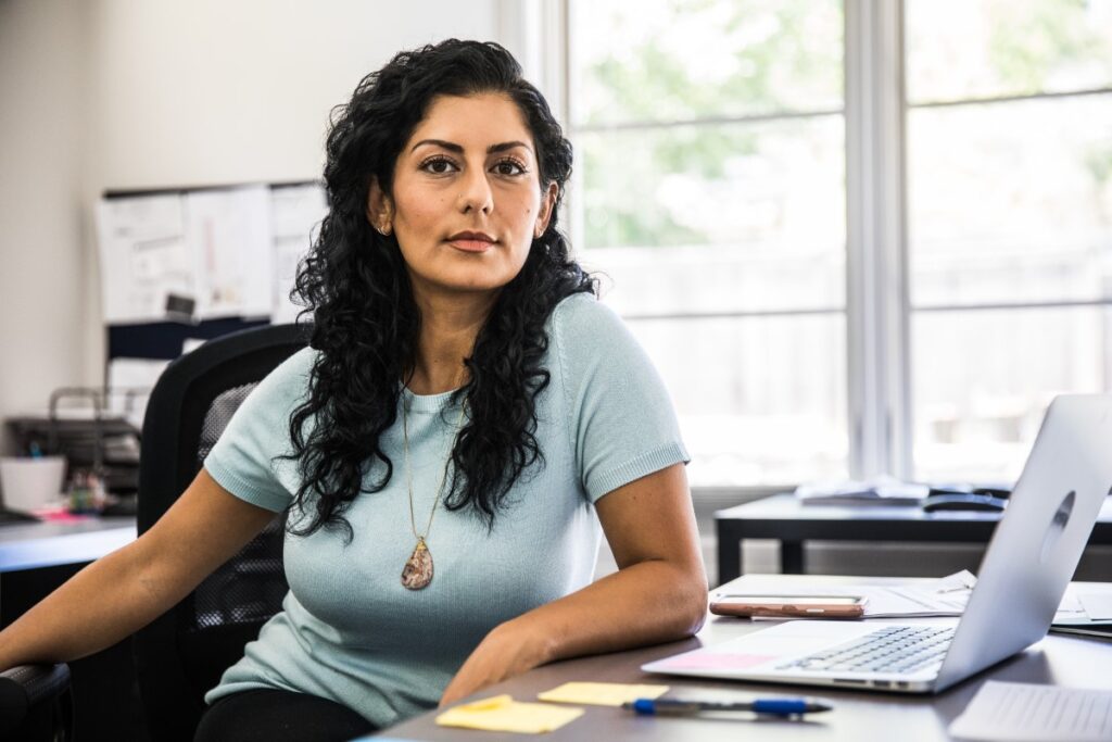 A woman sitting at a desk in an office.