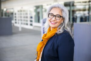 A portrait of a woman standing outside.