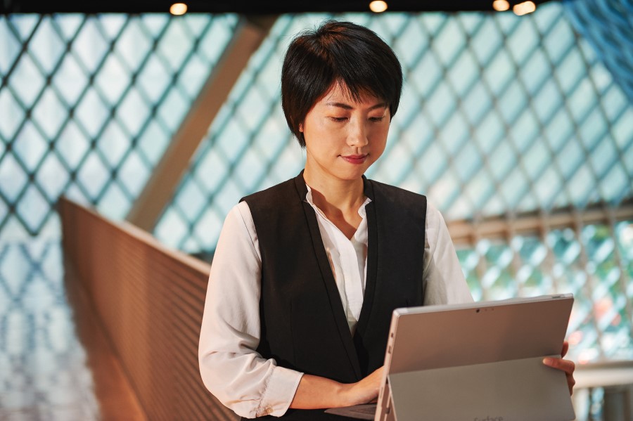 Woman using a Surface Pro inside a library.