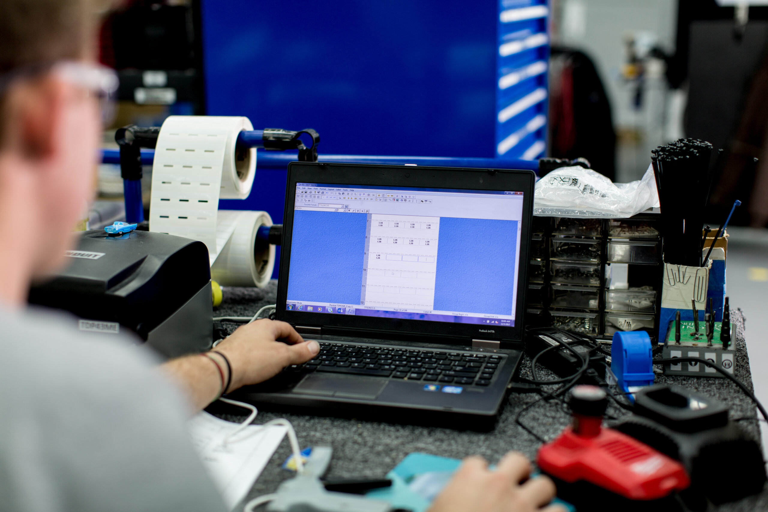 a person using a laptop computer sitting on top of a table