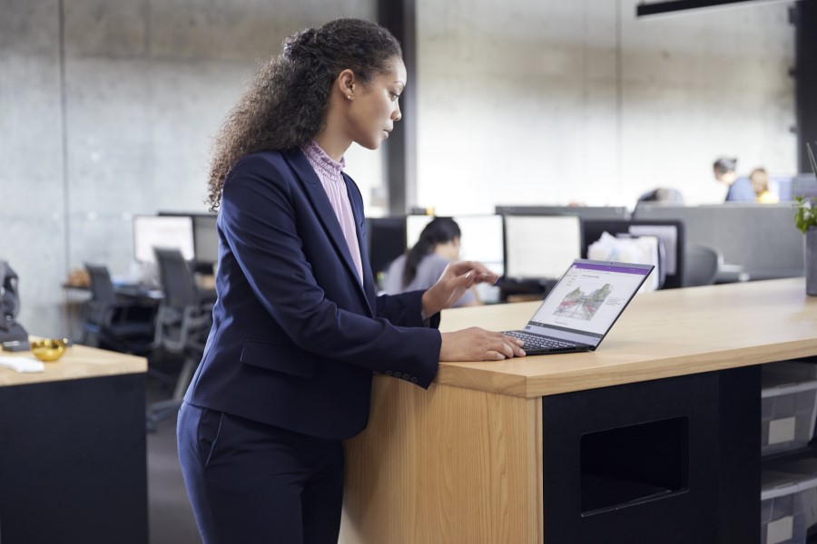 A business leader using Dynamics 365 solutions on a laptop computer.